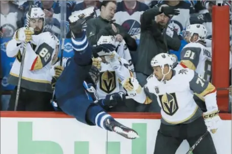  ?? JOHN WOODS — THE CANADIAN PRESS VIA AP ?? Winnipeg Jets’ Blake Wheeler gets dumped over the boards by Vegas Golden Knights’ Ryan Reaves (75) during period of Game 1 of the NHL Western Conference finals, Saturday in Winnipeg, Manitoba. The Jets won, 4-2. the first