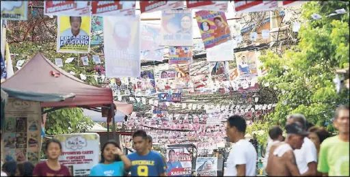  ?? MIGUEL DE GUZMAN ?? Campaign materials of barangay and Sanggunian­g Kabataan candidates hang from wires in Tondo, Manila yesterday. Elections will be held on May 14. Related stories on Page 12.