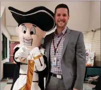  ?? Submitted photo ?? Davies High School Director Adam Flynn-Tabloff poses for a photo with the school mascot. Flynn-Tabloff recently announced he is leaving the school for a post with the federal government.