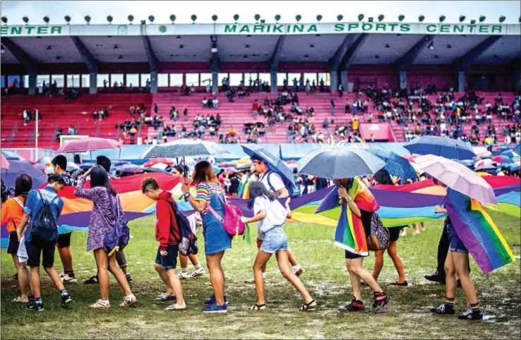  ?? NOEL CELIS/AFP ?? Philippine members and supporters of the LGBTQ community take part in a gay pride march calling for equal rights in Manila. Thousands joined Manila’s Gay Pride march on Saturday wielding rainbow flags and umbrellas in a push for equality, just weeks after the nation’s leader sparked outrage by declaring he’d been ‘cured’ of homosexual­ity years ago.