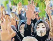  ?? AP ?? Protesters in Guy Fawkes masks raise their hands as they chant slogans during a rally in Hong Kong on Tuesday.