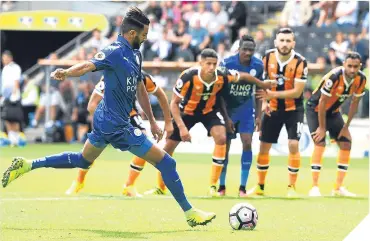  ??  ?? ■ Riyad Mahrez of Leicester City scores from the penalty spot to haul the Foxes level.