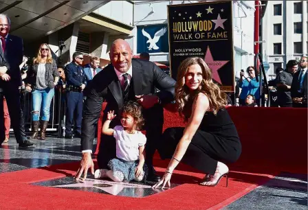  ?? — AFP ?? Stamp of approval: Johnson with Hashian and Jasmine posing on his Walk of Fame Star in Hollywood.