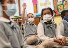  ?? New York Times file photo ?? First-graders wear masks in Bridgeport, Conn. In an experiment, school districts that maintained masking had few COVID cases.