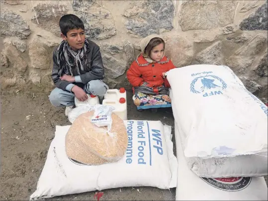  ?? Rahmat Gul / Associated Press ?? In this Jan. 2017 file photo, children wait for transporta­tion after receiving food donated by the World Food Program, in Kabul, Afghanista­n. On Friday, the WFP won the 2020 Nobel Peace Prize for its efforts to combat hunger and food insecurity around the globe.