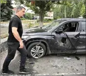 ?? ?? Mayor of Slovyansk Vadym Liakh passes by a car damaged by the Russian shelling in the city centre, in Slovyansk, Donetsk region, Ukraine