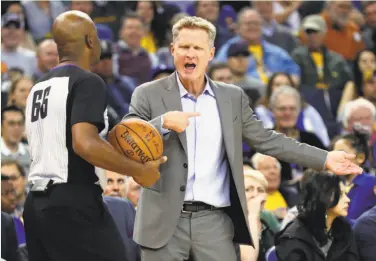  ?? Scott Strazzante / The Chronicle ?? Warriors coach Steve Kerr engages referee Haywoode Workman in a home win over Orlando last month.