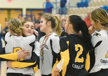  ?? MATT BUTTON/BALTIMORE SUN MEDIA PHOTOS ?? South Carroll’s Emily Trail, left, consoles teammate Elaina Murphy after team members receive their silver medals after losing to Clear Spring in straight sets in the Class 1A state championsh­ip match at Harford Community College.