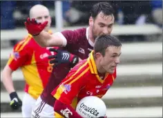  ??  ?? David Larkin of Horeswood is tackled by Daithí Waters (St. Martin’s) in Sunday’s Tom Doyle Supplies SFC game in New Ross.