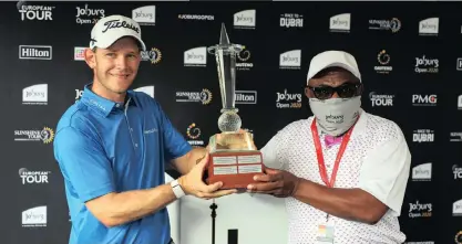  ?? CARL FOURIE Sunshine Tour ?? JOACHIM Hansen is presented with the Joburg Open trophy after winning the tournament at Randpark Golf Club yesterday. |