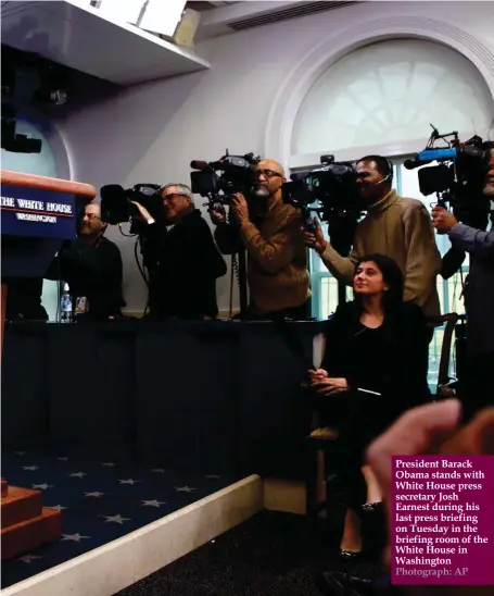  ?? Photograph: AP ?? President Barack Obama stands with White House press secretary Josh Earnest during his last press briefing on Tuesday in the briefing room of the White House in Washington