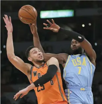  ?? MARK J. TERRILL — THE ASSOCIATED PRESS ?? U.S. Team’s Jaylen Brown, right, of the Celtics, passes the ball as World Team’s Ben Simmons, of the 76ers, defends during the NBA All-Star Rising Stars game, Friday in Los Angeles. The World Team won 155-124.