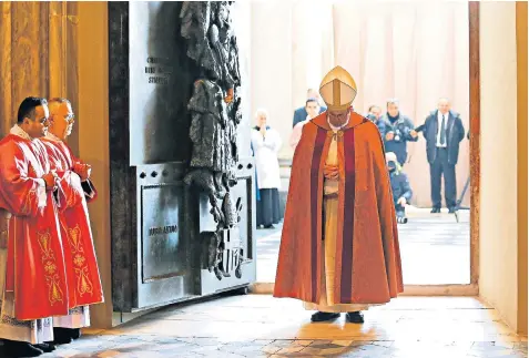  ??  ?? Pope Francis pauses for prayer after opening the Holy Door in Rome’s papal basilica of St John Lateran, the ‘mother of all churches’ for Roman Catholics
