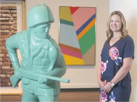  ?? TED RHODES ?? Melanie Kjorlien, curator of Glenbow at 50, stands beside Green Soldier No. 1, from 2001 by Douglas Coupland.