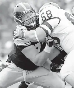  ?? By Reese Strickland, US Presswire ?? Building block: Iowa tackle Riley Reiff, left, blocking Michigan’s Mike Martin in November, could be the first offensive lineman selected in the draft.