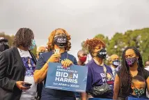  ?? DEMETRIUS FREEMAN/WASHINGTON POST ?? Supporters listen to then-presidenti­al nominee Joe Biden during a campaign event in Atlanta in October 2020.