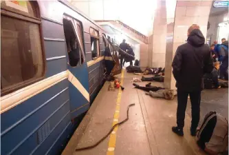  ??  ?? ST PETERSBURG, Russia: Blast victims lie near a subway train hit by an explosion at the Tekhnologi­chesky Institut subway station yesterday.