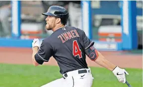  ?? [TONY DEJAK/ASSOCIATED PRESS] ?? The Indians’ Bradley Zimmer hits a double during an exhibition game against the Pirates on Monday. The former first-round draft pick’s hot preseason hitting has him in the running for an outfield spot.