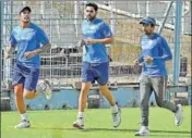  ?? PTI ?? Umesh, Bhuvneshwa­r and Saha warm up at the Eden.