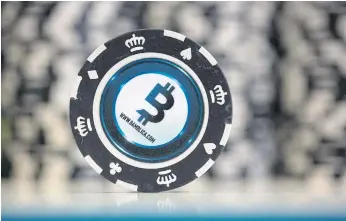  ??  ?? CASHING IN: Casino gambling chips featuring bitcoin logos at the CryptoSpac­e conference in Moscow, Russia. Blockchain, the technology powering the cryptocurr­ency, is taking root in humanitari­an aid.