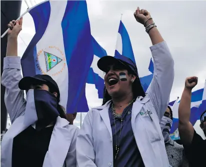  ?? INTI OCON/AFP/GETTY IMAGES ?? Medical students and doctors march against Nicaraguan President Daniel Ortega Tuesday in Managua.