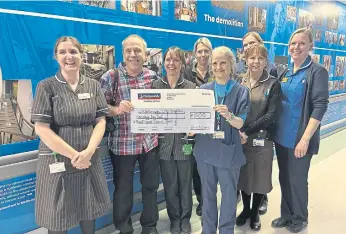  ?? ?? Chris presented a cheque to oncologist Karen McAdam and her team