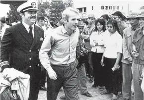  ?? AP ?? US Navy Lieutenant Commander John McCain, centre, is escorted to Hanoi’s Gia Lam Airport, after McCain was released from captivity in North Vietnam.