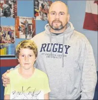  ?? CHRISTIAN ROACH/CAPE BRETON POST ?? Mitchell Jenkins, left, stands with his dad Wayne Jenkins on Thursday. Mitchell used the sales from his Glace Bay Minor Hockey Associatio­n 50-50 draw to sponsor another child to play hockey for the first time.