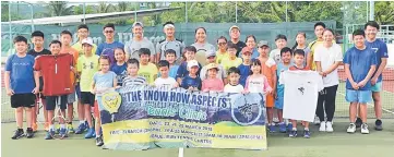  ??  ?? Christian (back row, sixth left wearing headband) with the participan­ts during the tennis clinic.