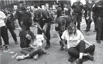  ?? ASSOCIATED PRESS ?? Police arrest activists as they block Fifth Avenue during a protest against President Donald Trump’s immigratio­n policies in New York.