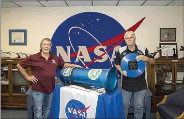  ?? JOSHUA FISHER / NASA ?? Andy Blua and Don Whitfield stand next to the time capsule they helped build in 1996.