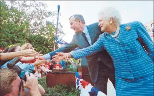  ?? LUKE FRAZZA/GETTY-AFP 1992 ?? President George H.W. Bush and first lady Barbara Bush shake hands with the crowd at a campaign rally on the steps of the Mississipp­i State Capitol in March 1992.