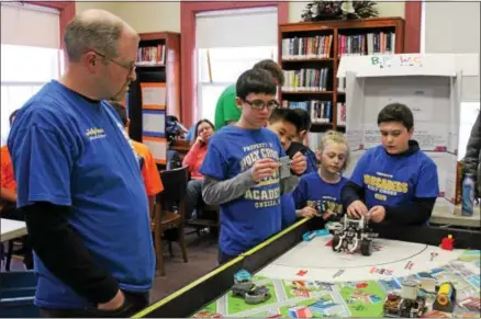  ?? CHARLES PRITCHARD — ONEIDA DAILY DISPATCH ?? Everlastin­g EV3, GenWorx Oughtamati­on, Dragon Bots of Clinton and Holy Cross Academy practice and perfect their robot designs and programmin­g as they prepare for regionals on Dec. 282017