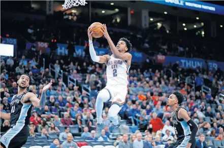  ??  ?? Thunder guard Shai Gilgeous-Alexander (2) soars to the basket between San Antonio's Trey Lyles (41) and Dejounte Murray (5) during a Feb. 11 game at Chesapeake Energy Arena. [BRYAN TERRY/ THE OKLAHOMAN]