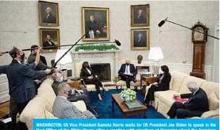  ?? —AFP ?? WASHINGTON: US Vice President Kamala Harris waits for US President Joe Biden to speak in the Oval Office of the White House after a meeting with members of Congress about the American Jobs Plan on Monday.