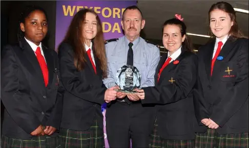  ??  ?? Members of Enniscorth­y’s Coláiste Bríde Student Council (Precious Obasohen, Beth Murphy, Niamh Crowhurst and Polly Maher) are presented with their award by Inspector Mark Foley.