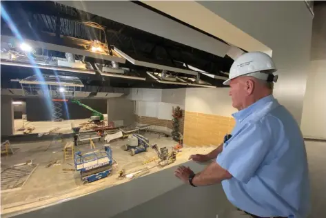 ?? (Special to The Commercial/Deborah Horn) ?? White Hall School District Superinten­dent Doug Dorris Jr. looks down at the stage in the center of the 1,250-seat auditorium inside the fine arts building under constructi­on.