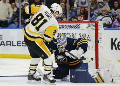  ?? Associated Press ?? Sabres goalie Linus Ullmark denies Phil Kessel in overtime Friday night in Buffalo, N.Y. The Sabres defeated the Penguins, 4-3 — the Penguins’ ninth loss in 14 overtime games this season.