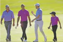  ?? PHELAN M. EBENHACK/ASSOCIATED PRESS FILE PHOTO ?? Tiger Woods, second from left, and his son Charlie, right, walk with Justin Thomas, second from right, and his father Mike Thomas on the third fairway during the first round of the PNC Championsh­ip in December 2020 in Orlando, Fla. Woods is returning to competitio­n at the tournament for the first time since he badly injured his right leg in a February car crash.