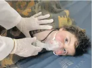  ?? IDLIB MEDIA CENTER VIA THE ASSOCIATED PRESS ?? A child is treated at a makeshift hospital following a suspected chemical attack in the Syrian town of Khan Sheikhoun on Tuesday. At least 11 children were killed.