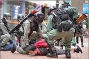  ?? PTI ?? Riot police detain a protester during a demonstrat­ion against Beijing’s national security legislatio­n in Causeway Bay in Hong Kong on Sunday. Hong Kong police fired volleys of tear gas in a popular shopping district as hundreds took to the streets Sunday to march against China’s proposed tough national security legislatio­n for the city