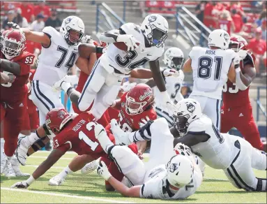  ?? Gary Kazanjian / Associated Press ?? UConn running back Kevin Mensah (34) goes up for a short gain against Fresno State on Saturday.