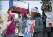  ?? RICK KAUFFMAN – DIGITAL FIRST MEDIA ?? Twins Dakota Puriefoy, right, and Sydney Puriefoy, center, celebrated their 11th birthday on Monday by joining their mother and aunt in protest of the Trump administra­tion in Yeadon. Their mom, Kia Puriefoy, said she allows her girls to ask questions...