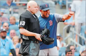  ?? MICHAEL OWENS/AP PHOTO ?? Red Sox manager Alex Cora argues with umpire Mike Estabrook after being ejected during the fourth inning of Boston’s 9-2 loss to the Yankees in Game 1 of a day-night doublehead­er Saturday in New York.