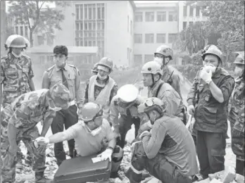  ?? PHOTOS PROVIDED TO CHINA DAILY ?? Members of the Clouded Leopard Rescue Team from Wuhan, Hubei province, work at the earthquake site in Nepal in April 2015.