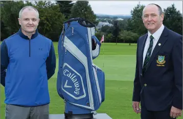  ??  ?? Derek Byrne, runner up at the recent Baltinglas­s Golf Club Captain’s Prize is presented with his prize by club captain Liam Horgan.