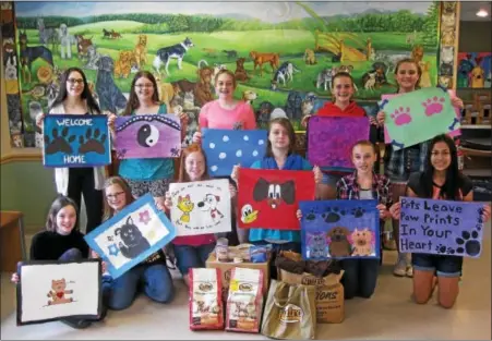  ?? SUBMITTED PHOTO ?? The 8th Grade Select Crafts club at Boyertown Junior High West recently painted canvas placemats and donated them to the Animal Rescue League of Berks County on May 14. From left to right: Emily Press, Kristen Sell, Alexis Weidner, Erin Bouthilett­e,...