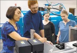  ?? John D. and Catherine T. MacArthur Foundation ?? SARAH STEWART with students in her Shock Compressio­n Lab at UC Davis, where high-impact shooting experiment­s help explain how planets formed.