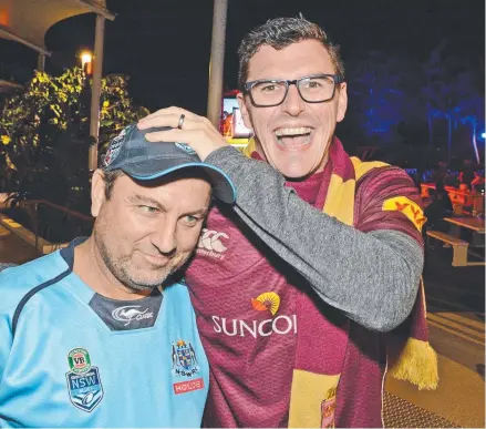  ?? Picture: REGINA KING ?? Maroons fan Paul Green chuckles at the plight of Blues supporter Dennis Mulheron at The Star Gold Coast.