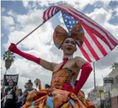  ?? — AFP ?? A protester wears a dress covered with faces of US President Donald Trump at the #ResistMarc­h during the 47th annual LA Pride Festival in Los Angeles, California, on Sunday.